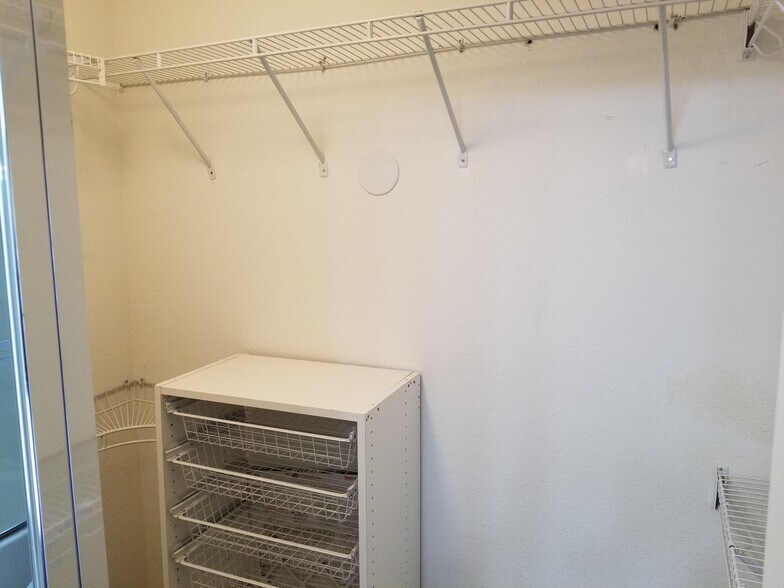 Walk-in master closet with built-in shelving organizer - 16939 Robins Nest Way