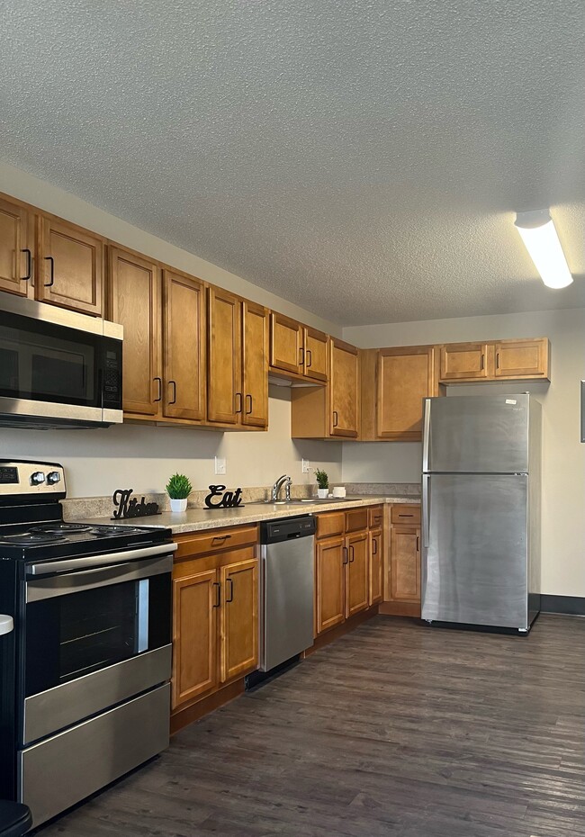 Ample Kitchen Storage with brand new cabinets, countertops and appliances - Lindenwood Senior Apartments