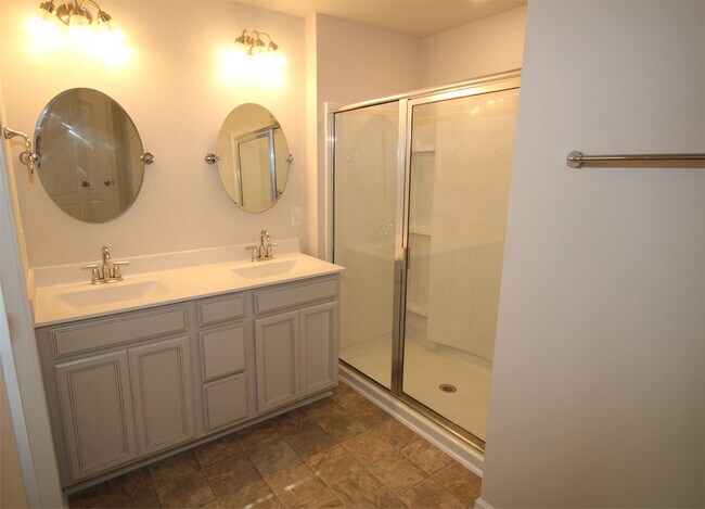 Master bath with 2 sink vanities and large shower. - 3406 Dropseed Dr