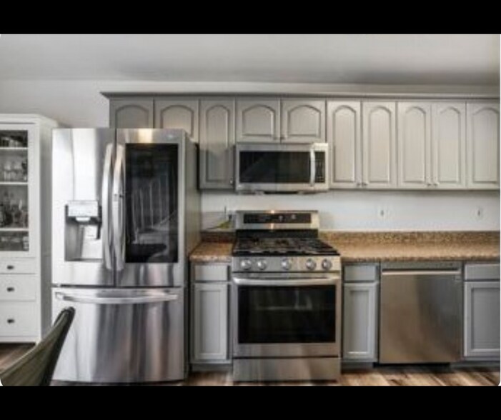 Kitchen with stainless steel appliances and ample cabinet space. - 940 Calla Ave