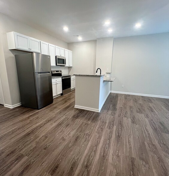Open-concept living area with plenty of natural light, seamlessly connecting to the kitchen & dining - 205 Cherry Way