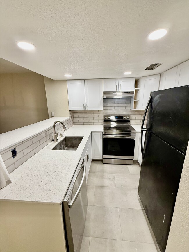 Renovated kitchen with quartz countertops and breakfast bar/nook - 3301 Monroe St NE