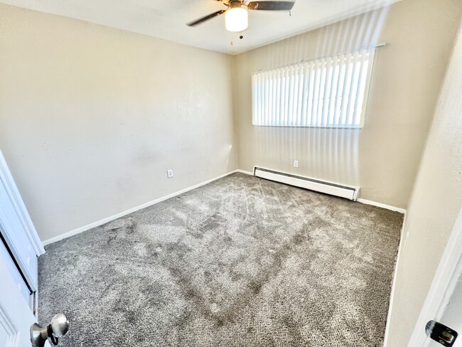 Experience comfort in a well-lit bedroom with modern amenities. - 1690 Eaton