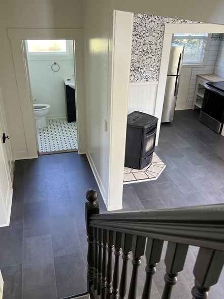 Looking downstairs to hallway with bathroom - 557 Washington St