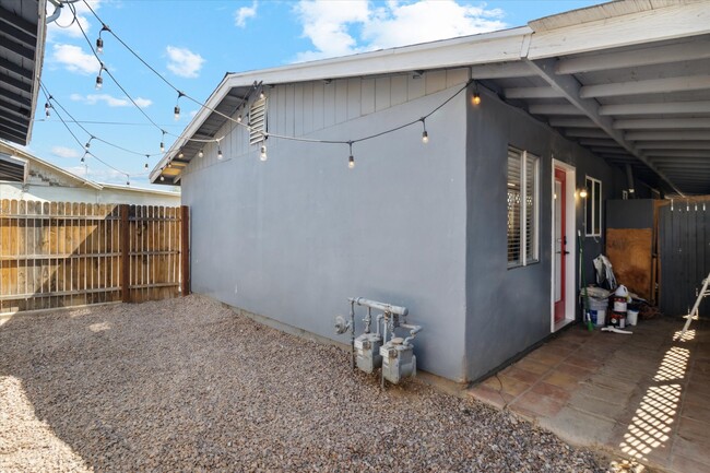 Private backyard, perfect for pets. Decorative lights already hung for you! - 327 N 16th Ave