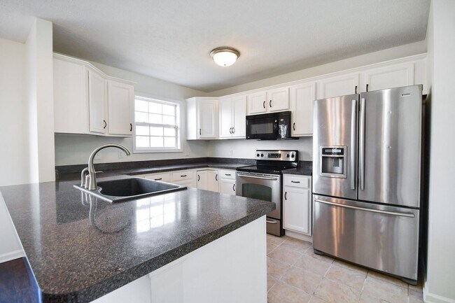 Building Photo - Pet Friendly Three Bedroom with Bonus!