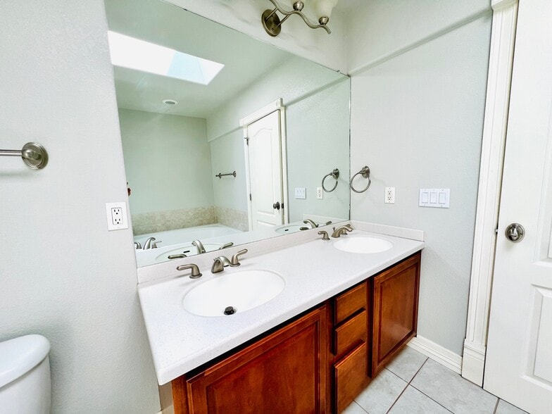 Master bathroom with skylight allowing for lots of natural lighting to come through. - 2317 Decatur St