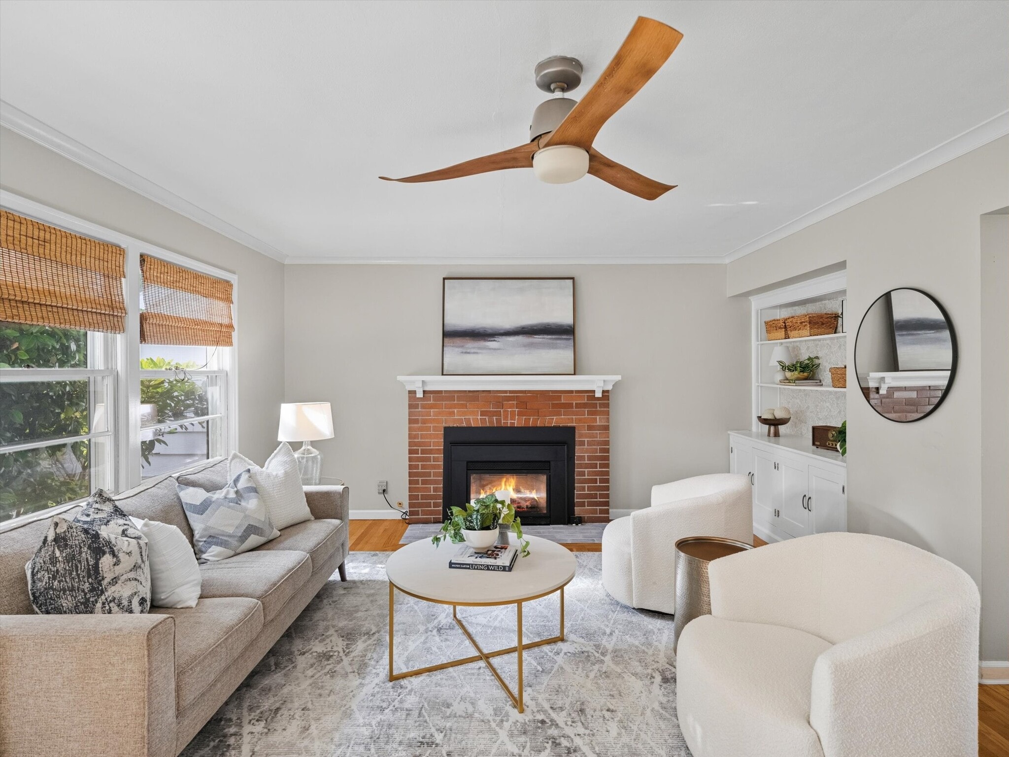 The living room features a gas fireplace and ceiling fan. - 9835 SW 80th Ave