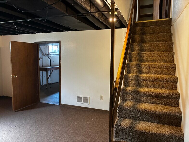 At the base of the basement stairs, this is the finished part of the basement - 1205 Randolph St