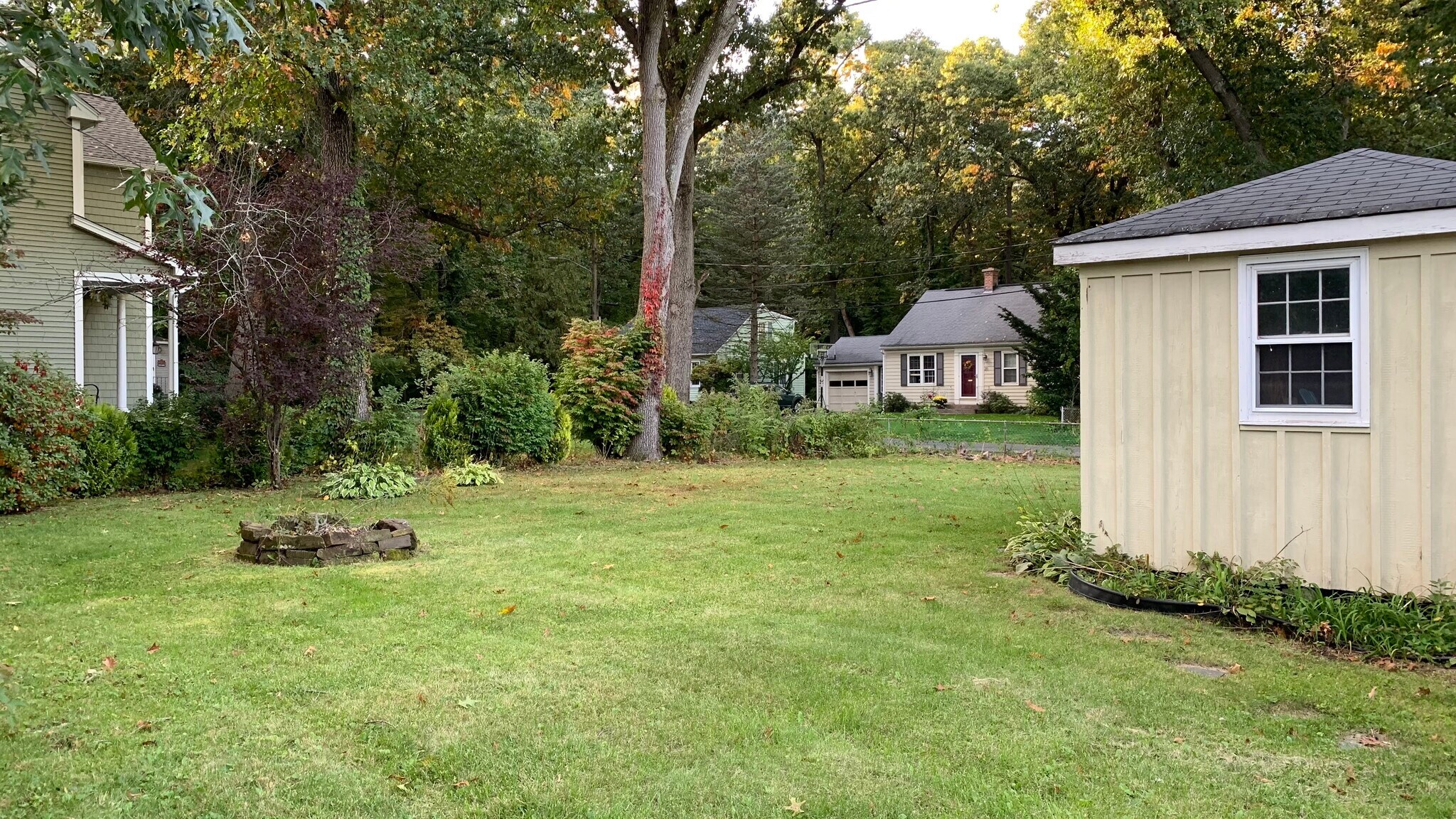 Shed and more of the backyard adjacent to driveway. - 58 Oakwood Dr