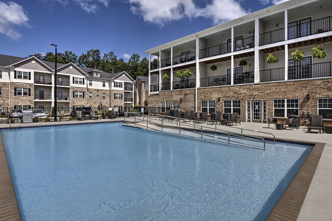 Outdoor pool with lounge chairs at Retreat at the Park apartments for rent in Burlington, NC - The Retreat at the Park