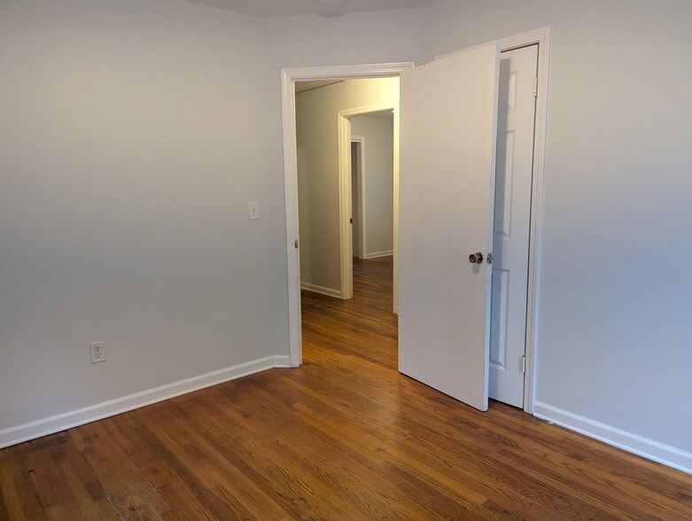 Hallway connecting bedrooms and living areas with ample closet storage. - 1527 Brookbank Ave
