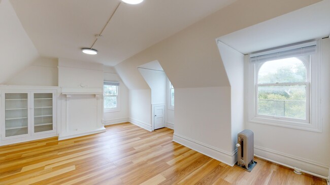 Sunlit room with a large window and wood-like flooring - 2129 Haste Street