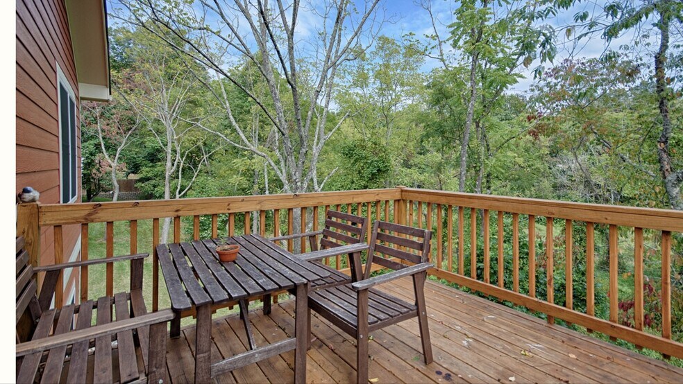 Deck off the main level overlooking the fenced back yard and trees - 144 Estelle Park Dr