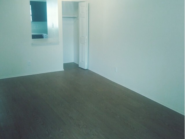 Living Room w/Laminate Flooring - Orangewood Lakes Apartments