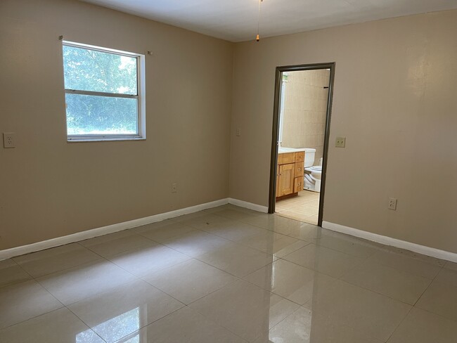 Primary bedroom looking into primary bathroom - 6722 Fern Circle