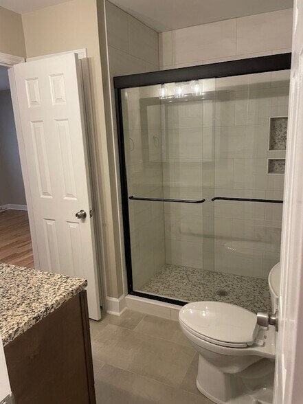 Renovated bathroom with new walk in shower and vanity. - 815 Lexington Ave