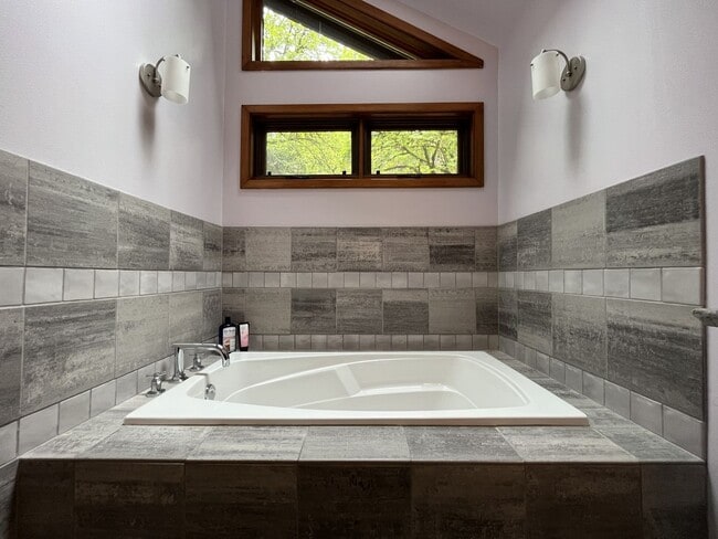 Building Photo - One-of-a-Kind Custom Home with Wall of Windows, Stone Fireplaces, Expansive Entertainment Space &...