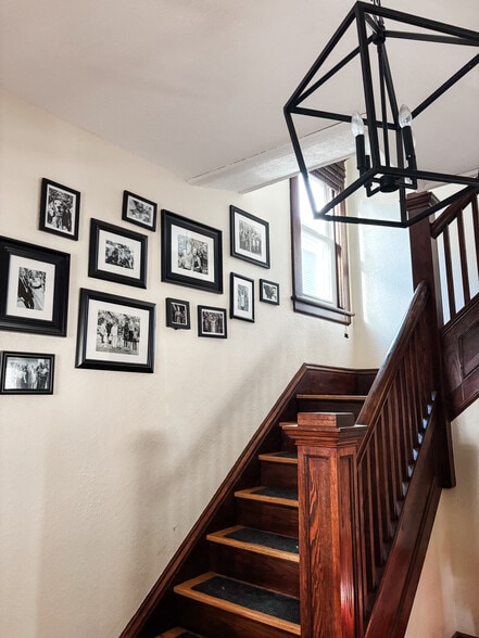 Your entryway includes a modern light and classic wood banister. - 819 Edmund Ave