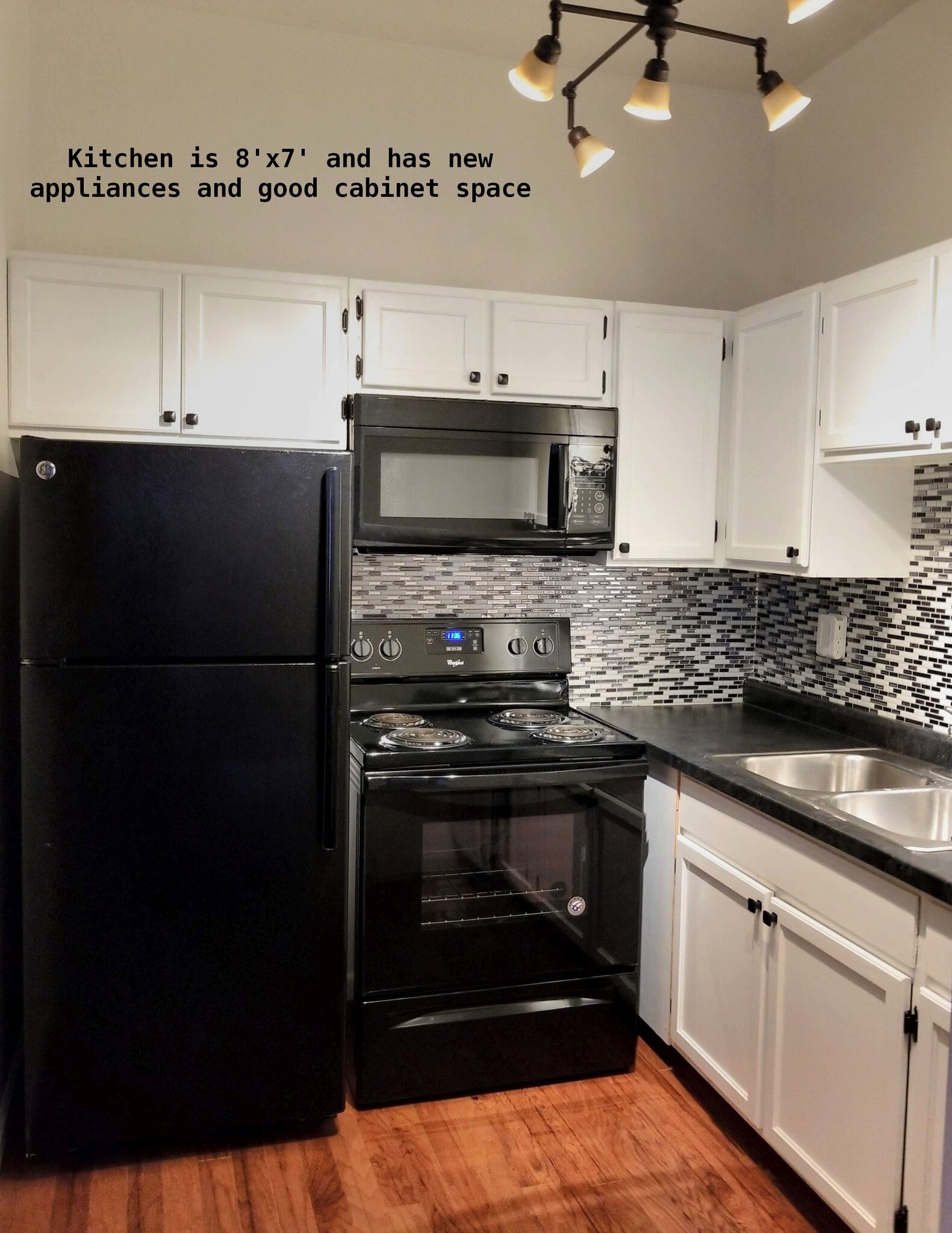 Kitchen is black, white and stylish gray accents with new appliances - 810 E Washington St