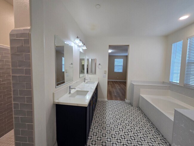 Building Photo - Open-Concept Living with Downstairs Bedroom & Enclosed Patio Retreat