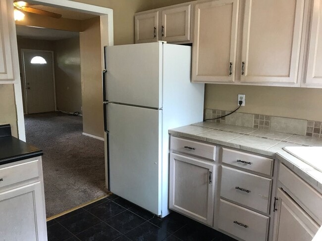 Building Photo - Nice, 4BR rancher with appliances, attached garage and fenced back yard.