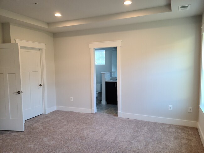 Master bedroom with attached bathroom and walk-in closet - 1310 Cougar Ln