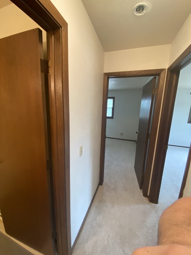 Hallway with access to bedrooms, bathroom, and living room - 2912 12th St S