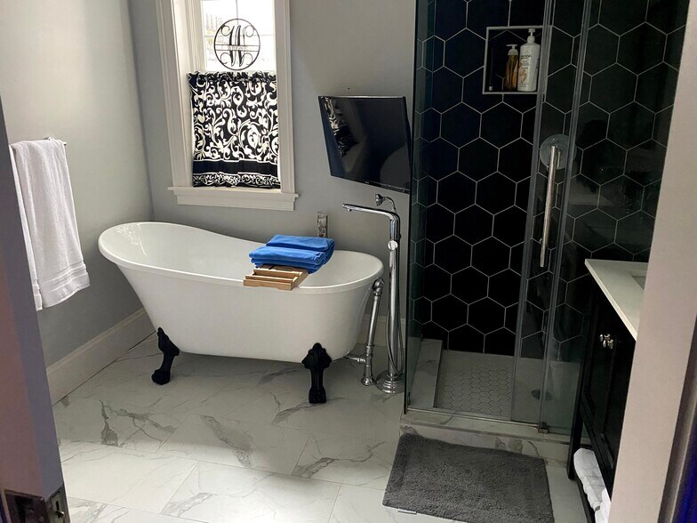 2nd floor primary bathroom with clawfoot tub, separate shower, and double vanity - 17 U St NW