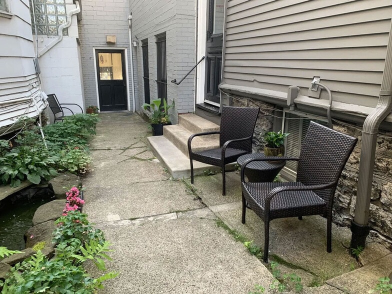 Private courtyard garden; Hallway to Elmwood on left, door to apartments on right. - 485 Elmwood Ave
