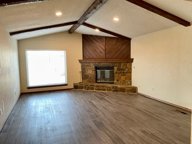 Vaulted ceilings in the large living room with dimmable lights and a view of the side yard - 100 Village Oaks Dr