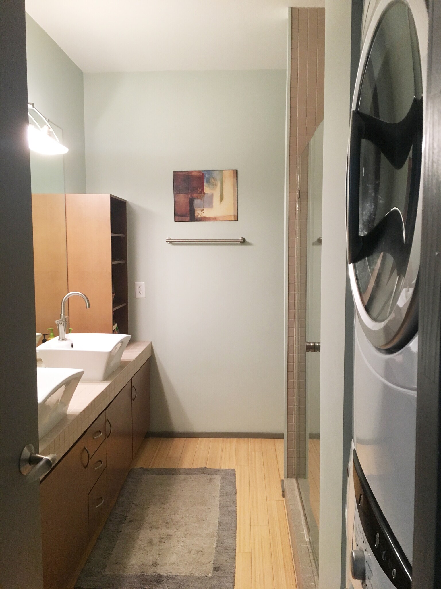 Master bathroom offers stackable laundry, double vanity, and walk-in shower. - 2074 Euclid Ave