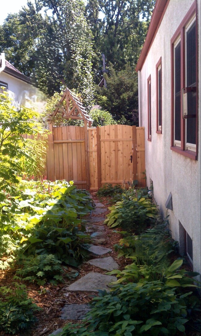 Side walkway with landscaped surroundings. - 2923 Arthur St NE