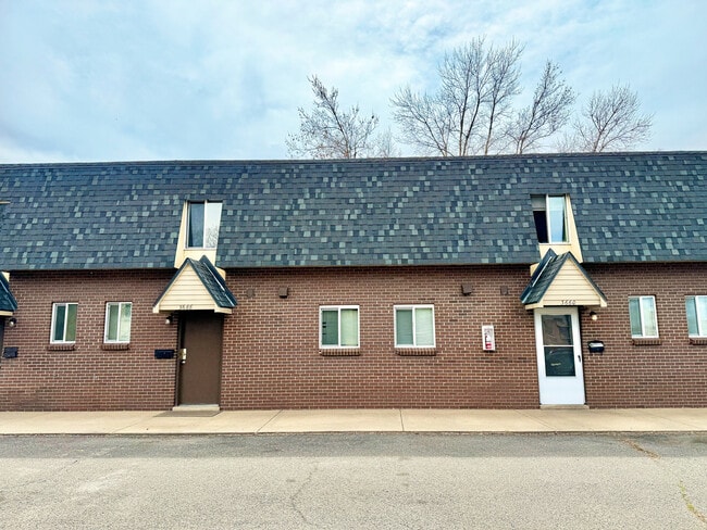 Charming brick townhouse exterior with modern windows and distinctive roof design, ideal for comfortable urban living. - 3650 Upham St