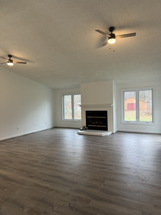 Open living room with high ceilings and gas fireplace - 465 N Burkhart Rd