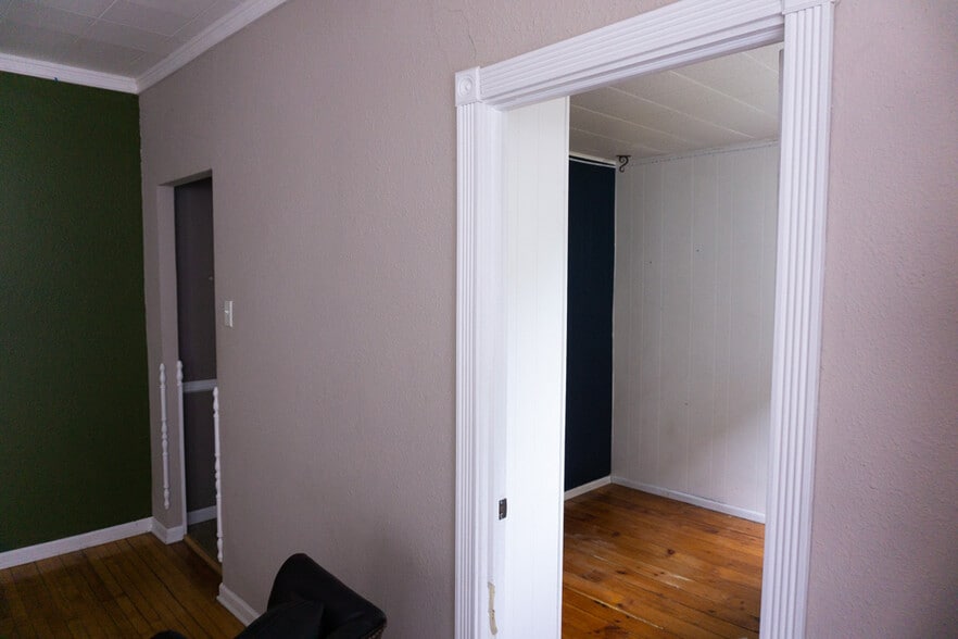 View into second bedroom and entrance to kitchen from dining/living space, facing north - 622 End Ct