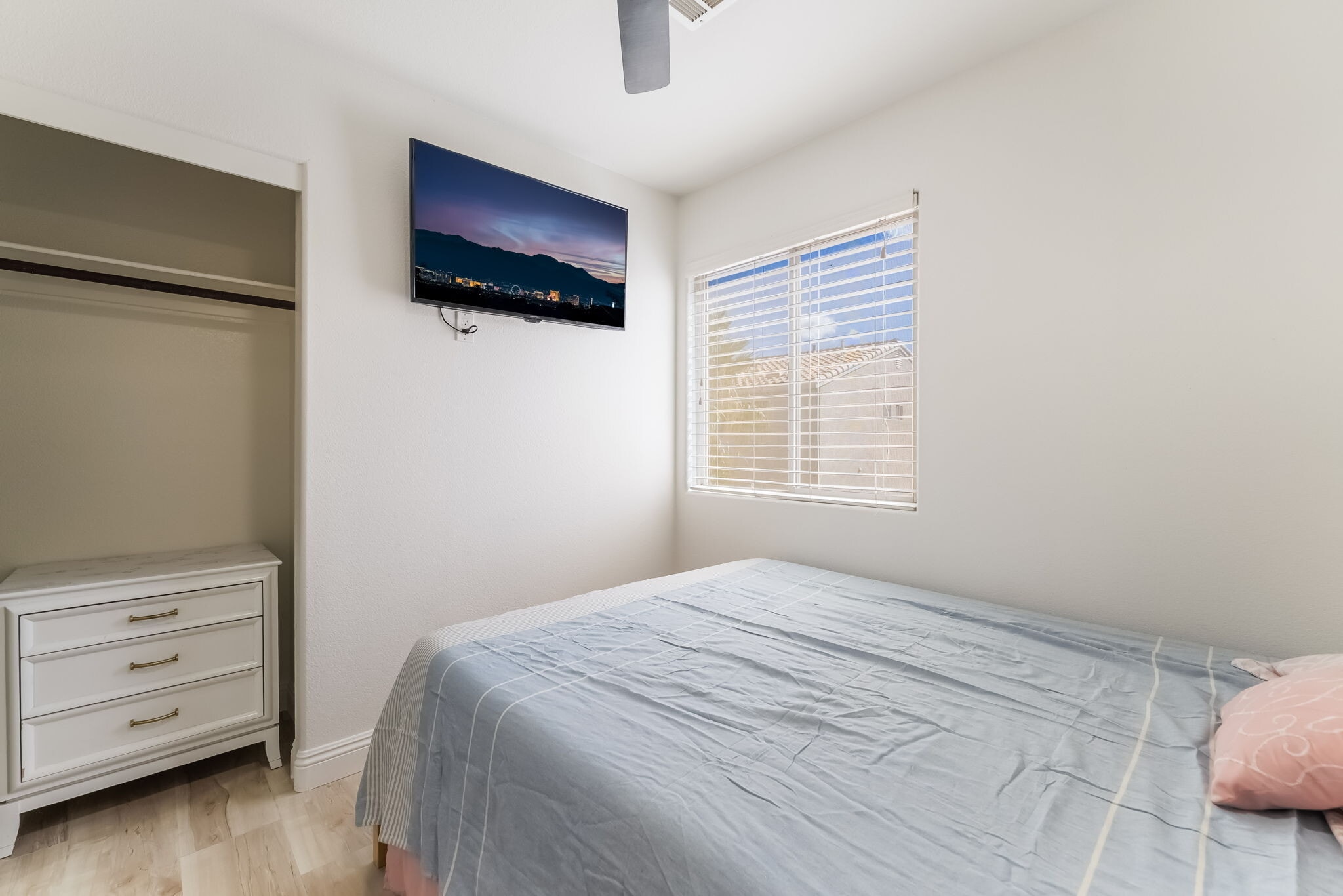 Bedroom featuring light wood finished floors and ceiling fan - 1179 Antoinette St