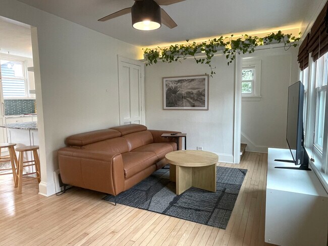 Bright, inviting living room with original hardwood floors - 3209 Atwood Ave