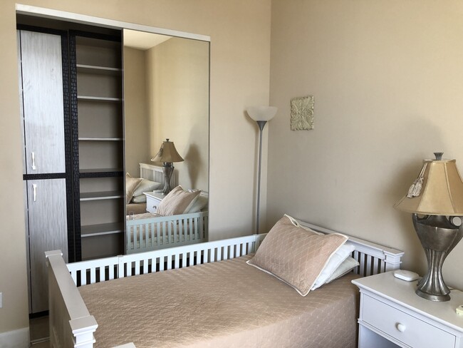 Second bedroom with two separate beds which can be converted into the bank bed. Baby crib available - 15901 Collins Ave