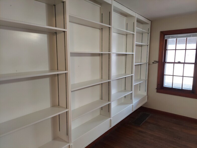Built-in bookcases in the large living room for readers, collectors, or display. - 1201 N Madison St