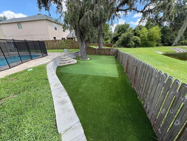 Building Photo - Spacious 5-Bedroom Pool Home with Putting ...