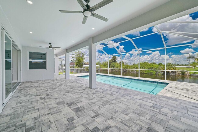 Building Photo - NOW AVAILABLE - Gorgeous Pool Home ~ NW Cape ~ 3 Car Garage ~ On Canal!