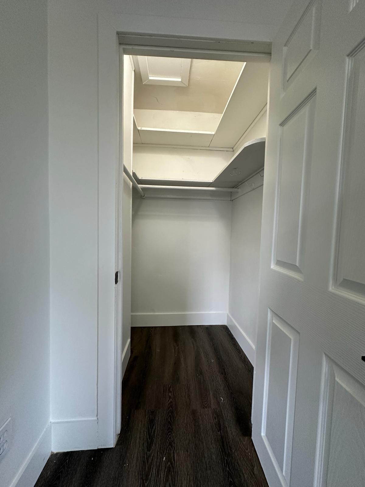 View of the closet with dark hardwood flooring - 1247 N Florissant Rd