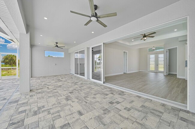 Building Photo - NOW AVAILABLE - Gorgeous Pool Home ~ NW Cape ~ 3 Car Garage ~ On Canal!