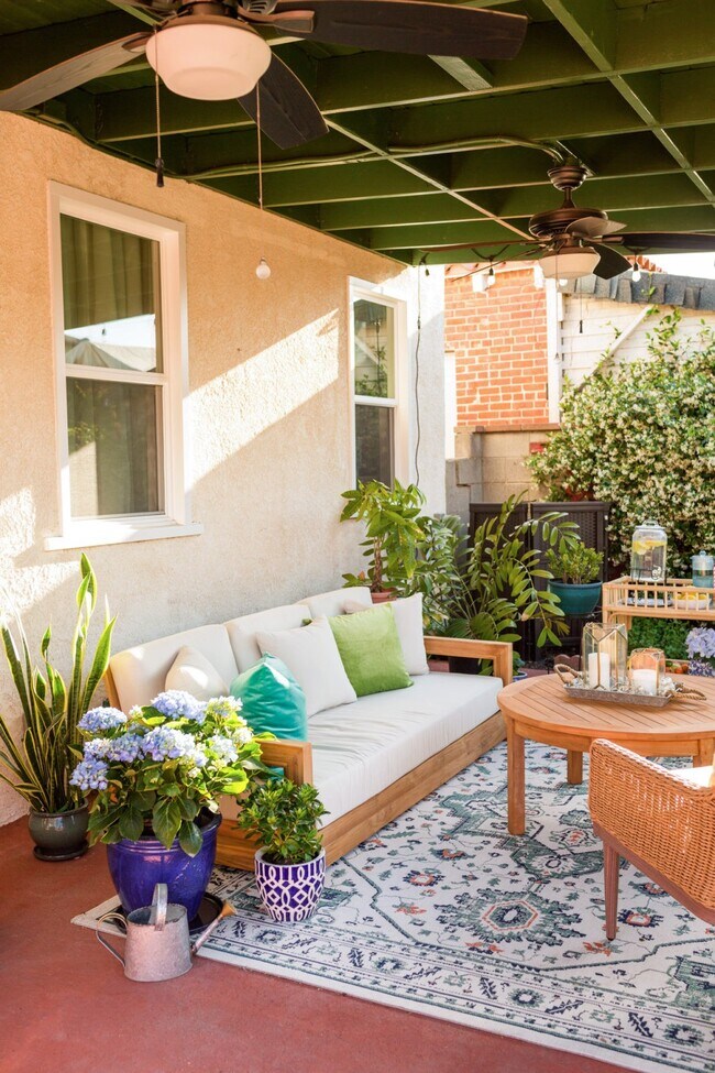 Evening light in the back patio complete with ceiling fans and market lights. - 1150 W 25th St