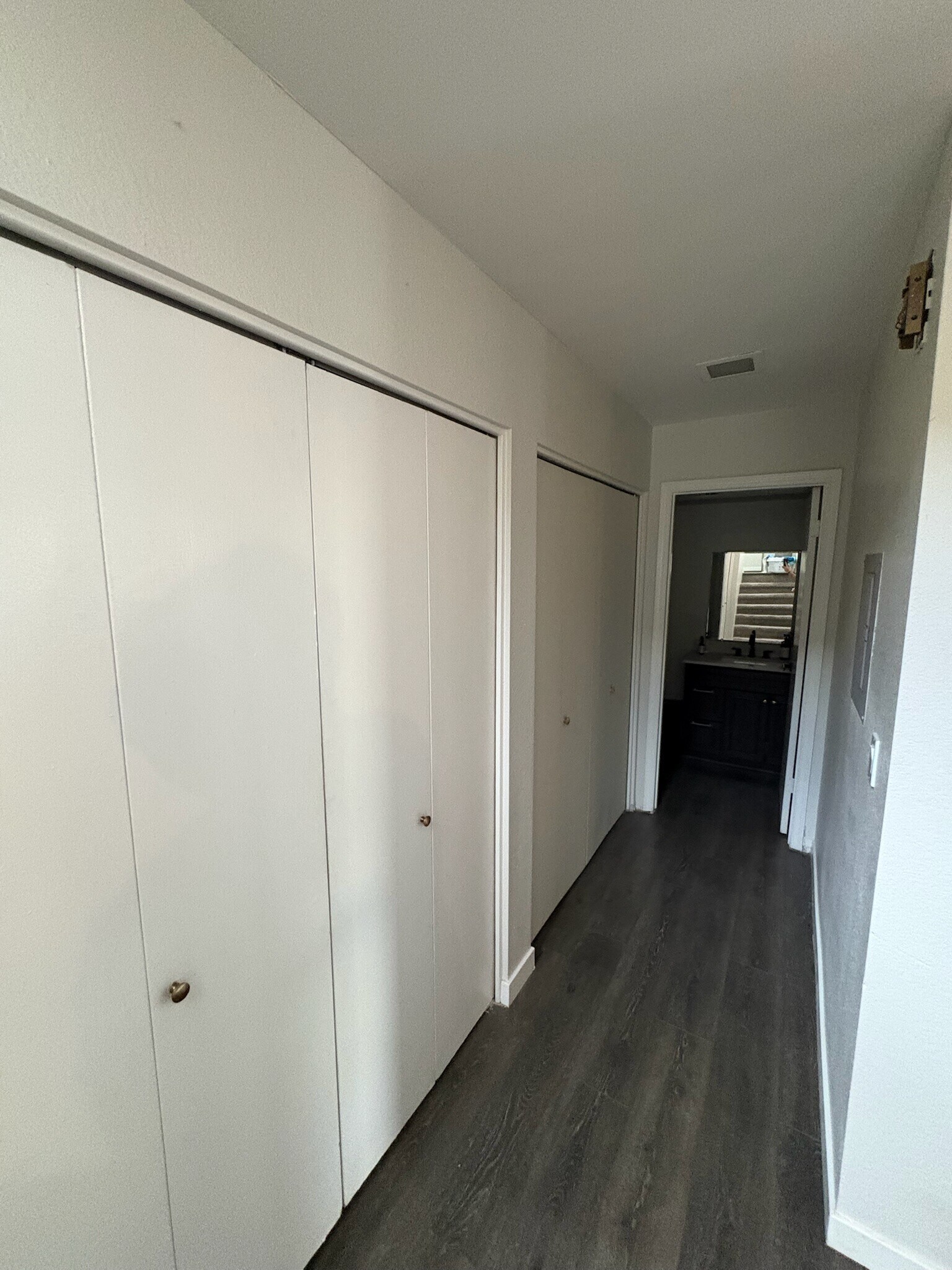 Hall to half bathroom with closet and laundry room - 3315 E Kelton Ln