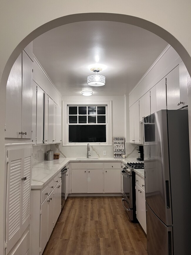 Sleek and modern kitchen with elegant white cabinets and all-new paint. All new appliances. - 1880 Jackson St