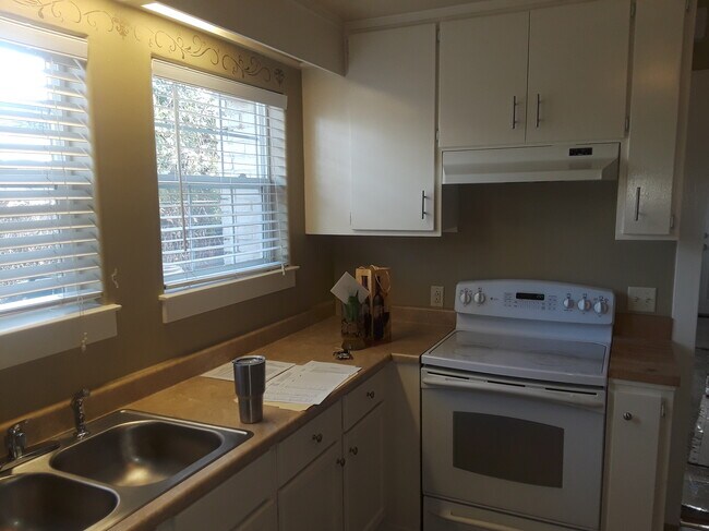 Kitchen at sink & stove - 608 Elefa St