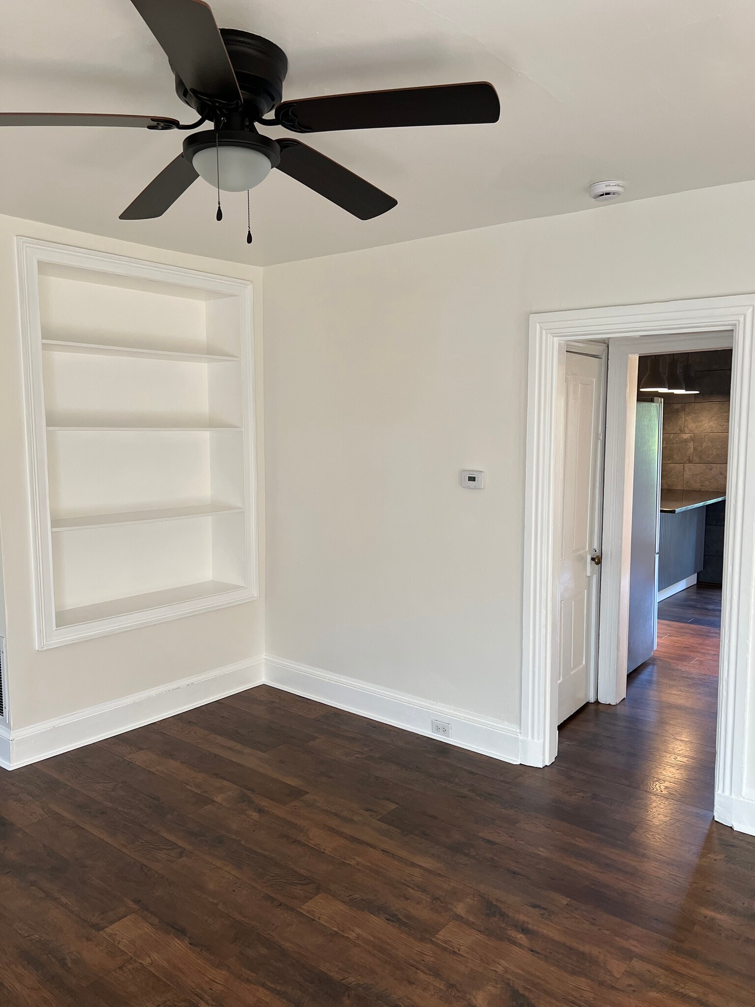 From the living room, a short hallway leads to the kitchen with doors to the basement and pantry. - 126 Merion Ave