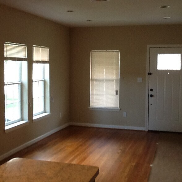 Original wood floors in the living room and kitchen. - 429 W 2nd St